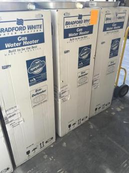 Bradford white water heaters and drip pans, ready for installattion in Arlington, Virginia